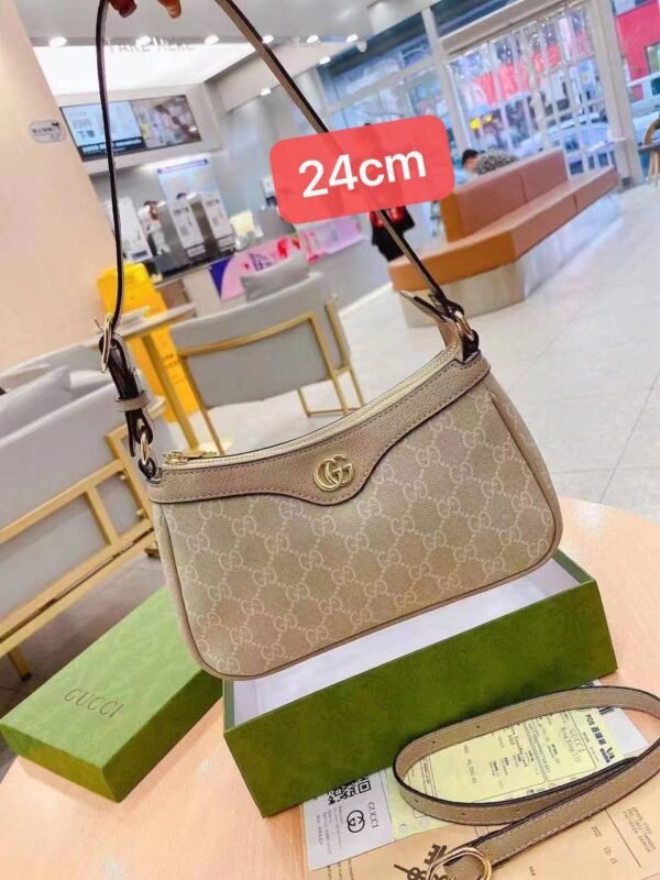 Gucci shoulder bag, adorned with the iconic logo and packaged in its original box 24 cm