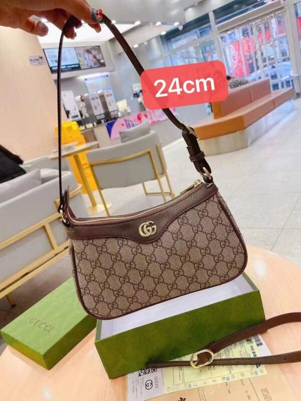 Gucci shoulder bag, adorned with the iconic logo and packaged in its original box 24 cm