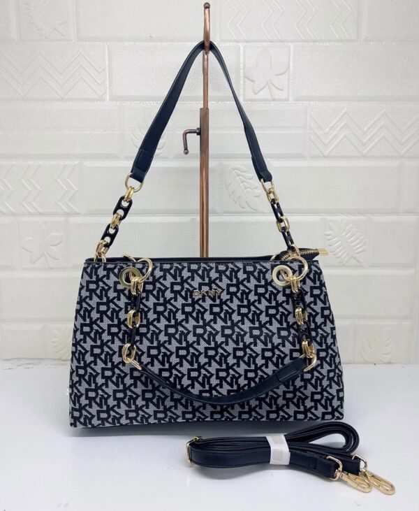 the chic and versatile DKNY Shoulder Bag, designed to elevate your everyday style. Measuring 33 cm, this bag offers ample space for your essentials
