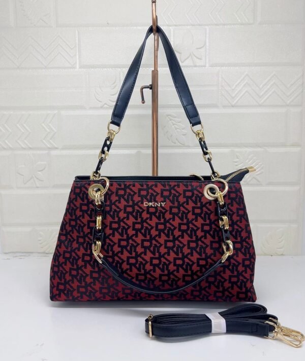 the chic and versatile DKNY Shoulder Bag, designed to elevate your everyday style. Measuring 33 cm, this bag offers ample space for your essentials